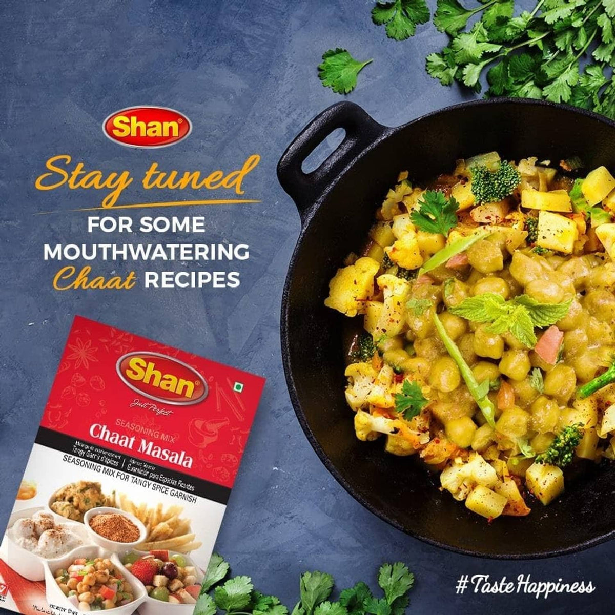 Shan Chaat Masala seasoning packet next to cooked chaat in black skillet, promotional