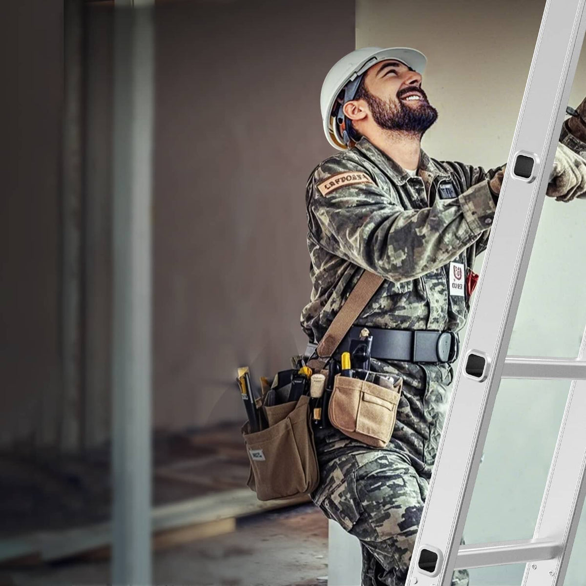 Worker climbing a folding ladder with hand on side rail, white ladder frame
