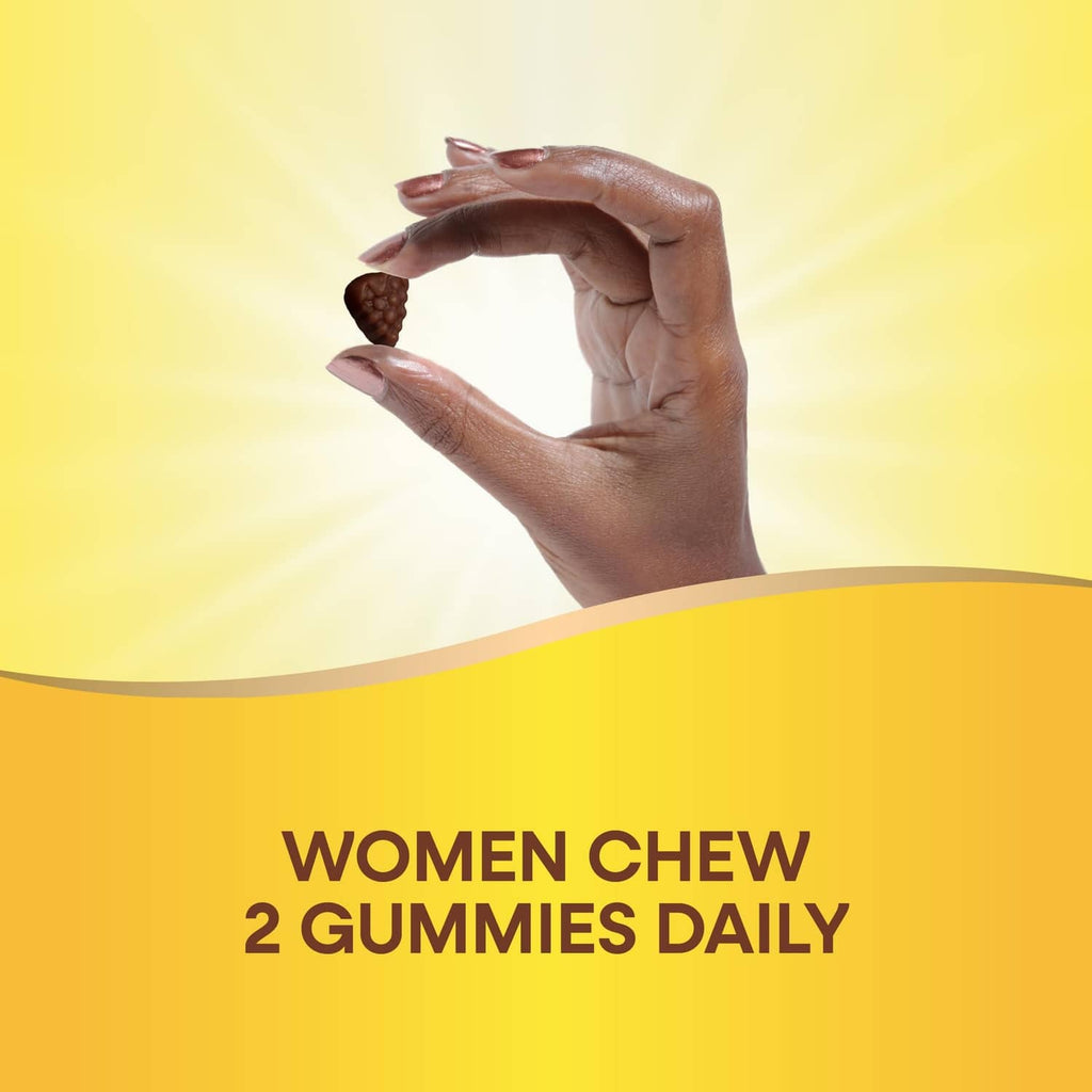 Hands holding two multivitamin gummy pieces