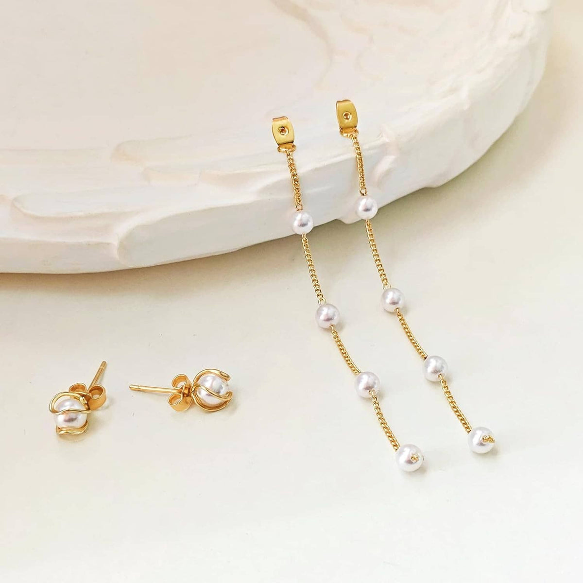 Gold pearl drop earrings with white pearls and top hook caps