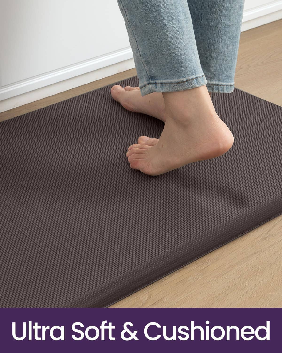 Cushioned kitchen mat underfoot, dark gray textured surface with soft support