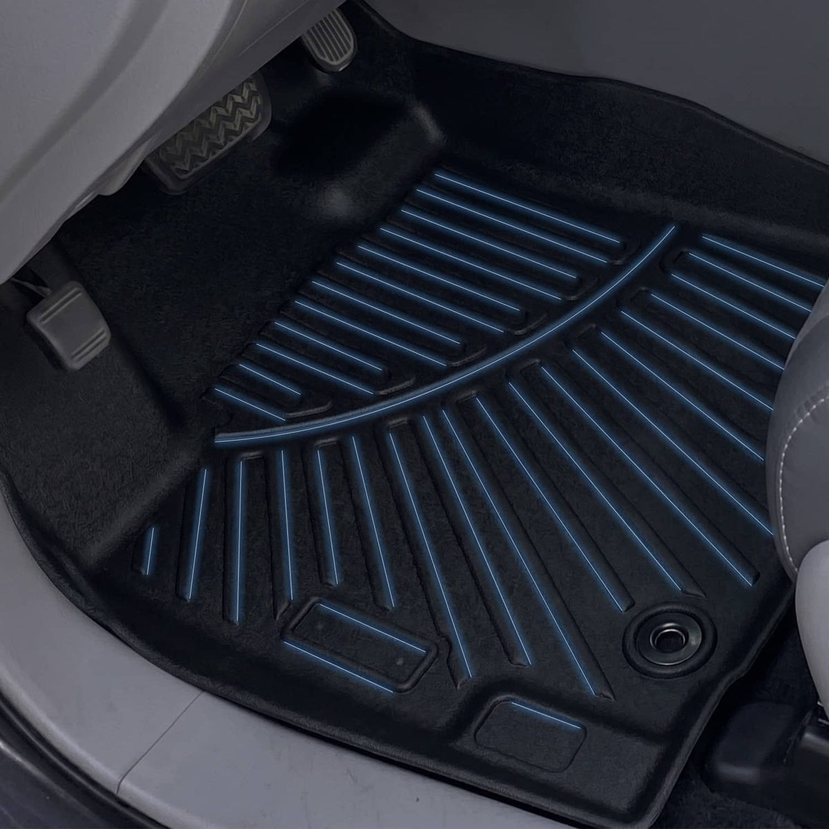 Black TPE all-weather floor mat with deep grooves and raised channels close-up