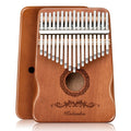 Brown 17-key kalimba thumb piano with circular sound hole and engraved front panel