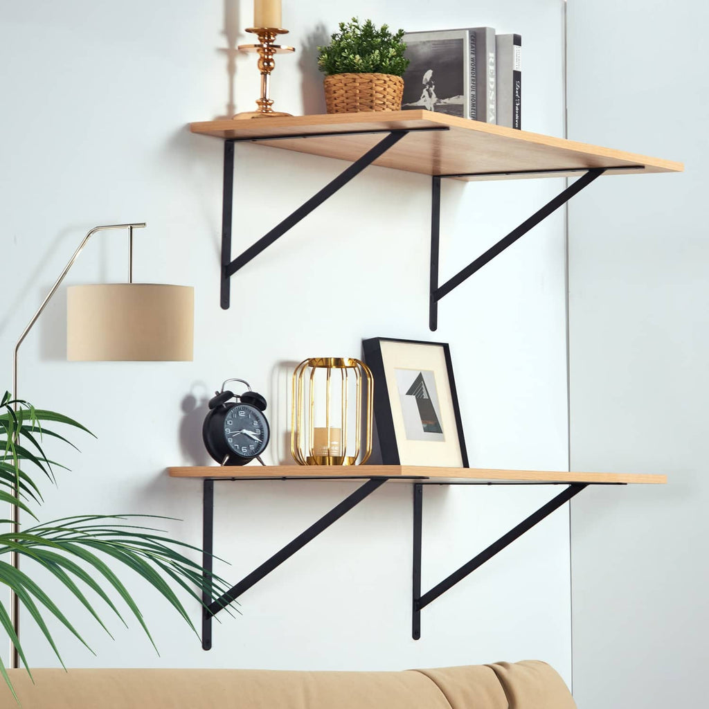 Triangular floating shelf brackets in black metal under wooden shelves