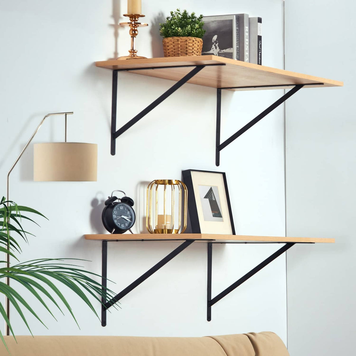 Triangular floating shelf brackets in black metal under wooden shelves