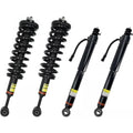 Set of four black shock strut assemblies with coil springs, top mounts, and bushings
