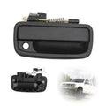 Black plastic exterior door handle with round key hole and visible torsion spring