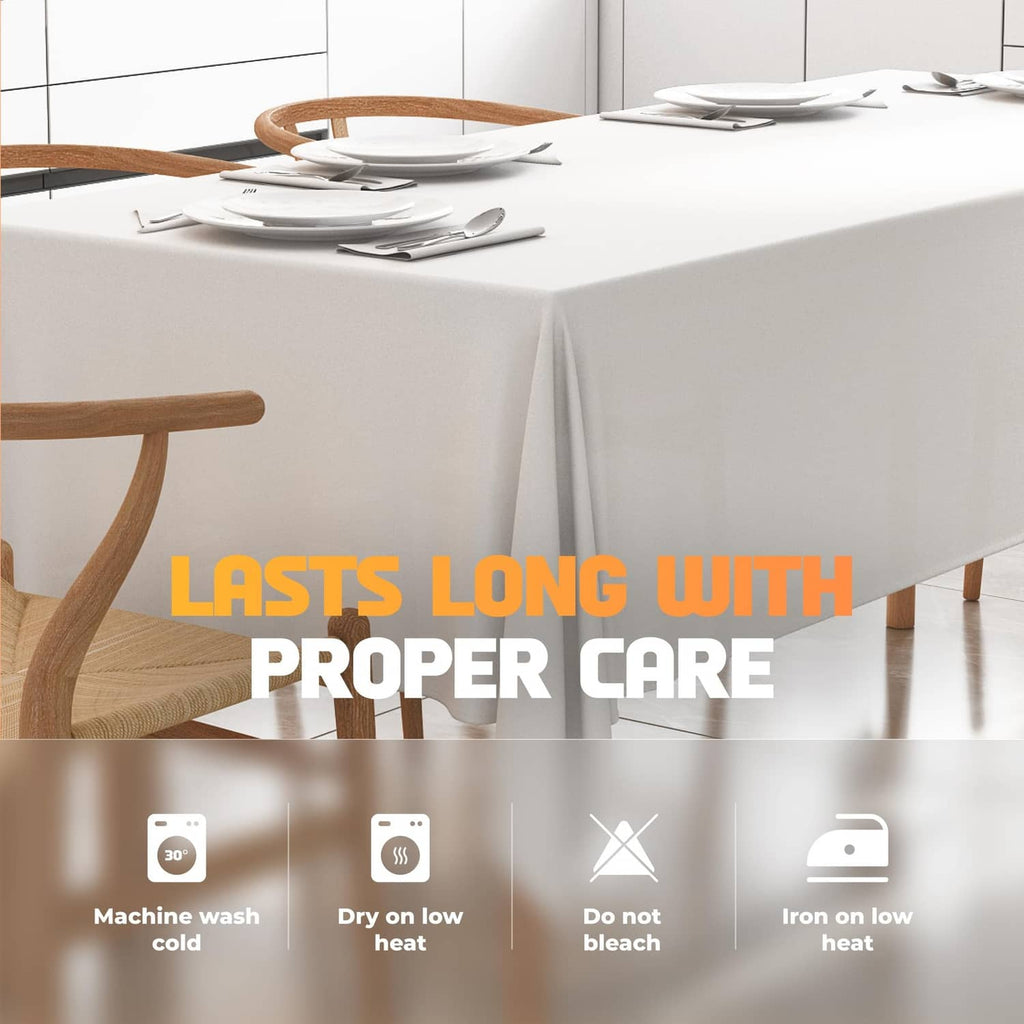 White tablecloth on a table with care icons for machine wash and low-heat iron