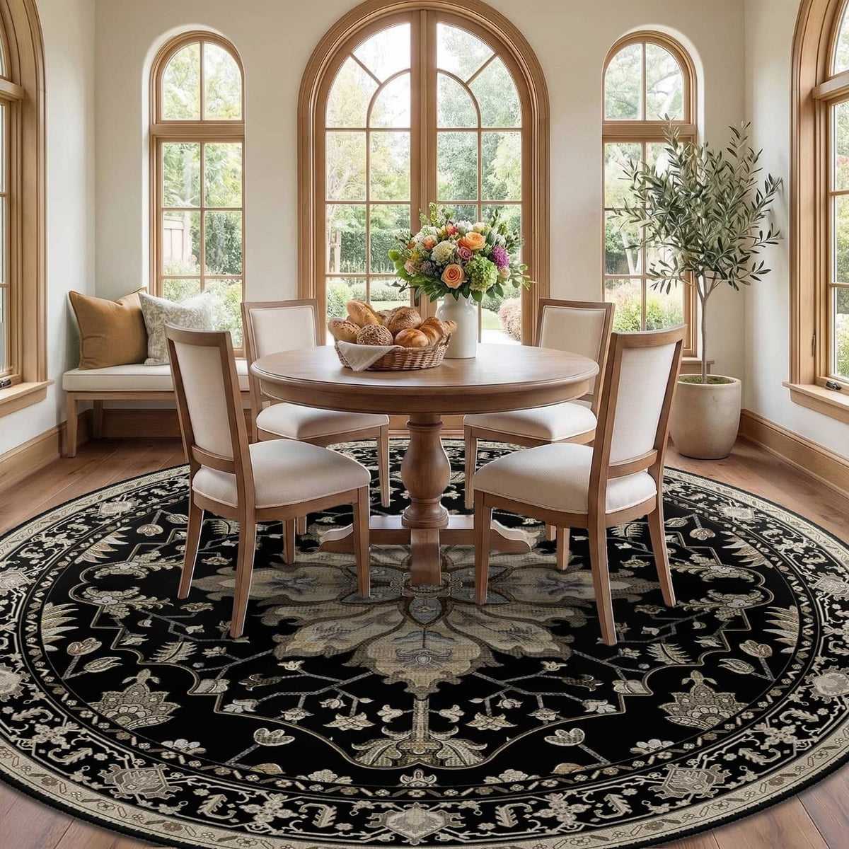 Round black area rug with decorative light floral medallion in a dining room
