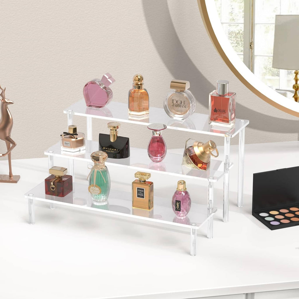 Clear acrylic 3-tier perfume display stand with multiple fragrance bottles