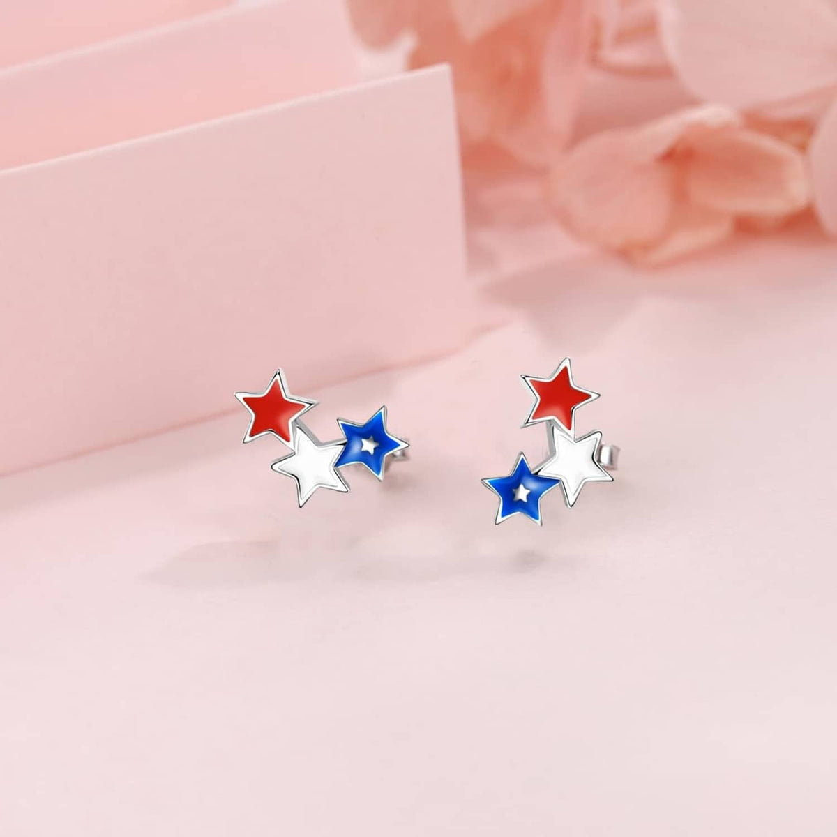 Star stud earrings featuring red, white, and blue enamel stars on silver-tone