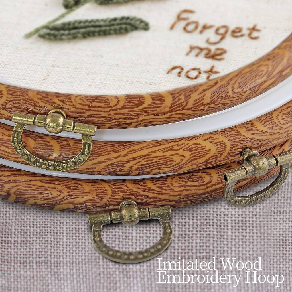 Wood-look embroidery hoop close-up with metal latch and white inner ring
