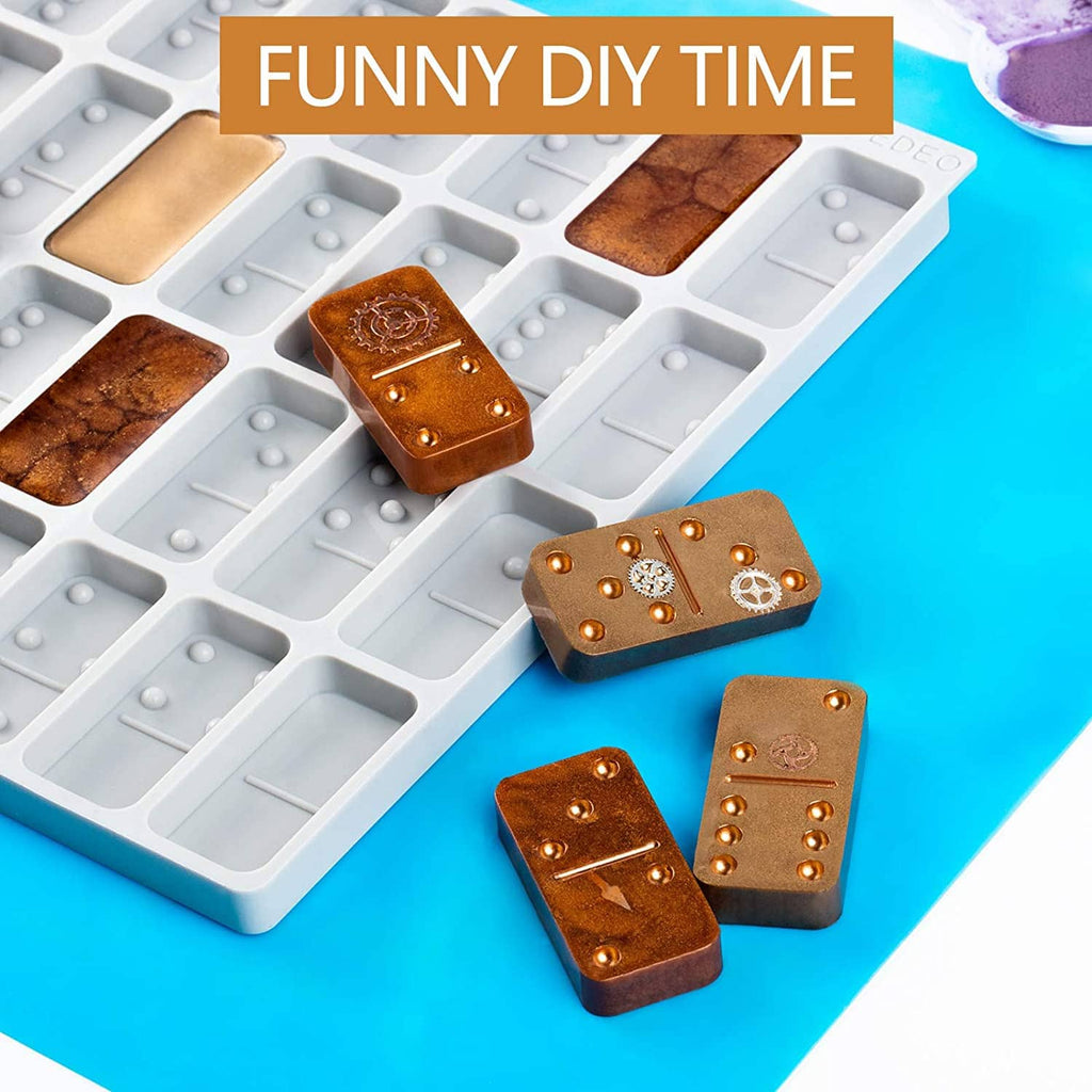 Round thick domino silicone mold with several brown domino pieces showing raised pips