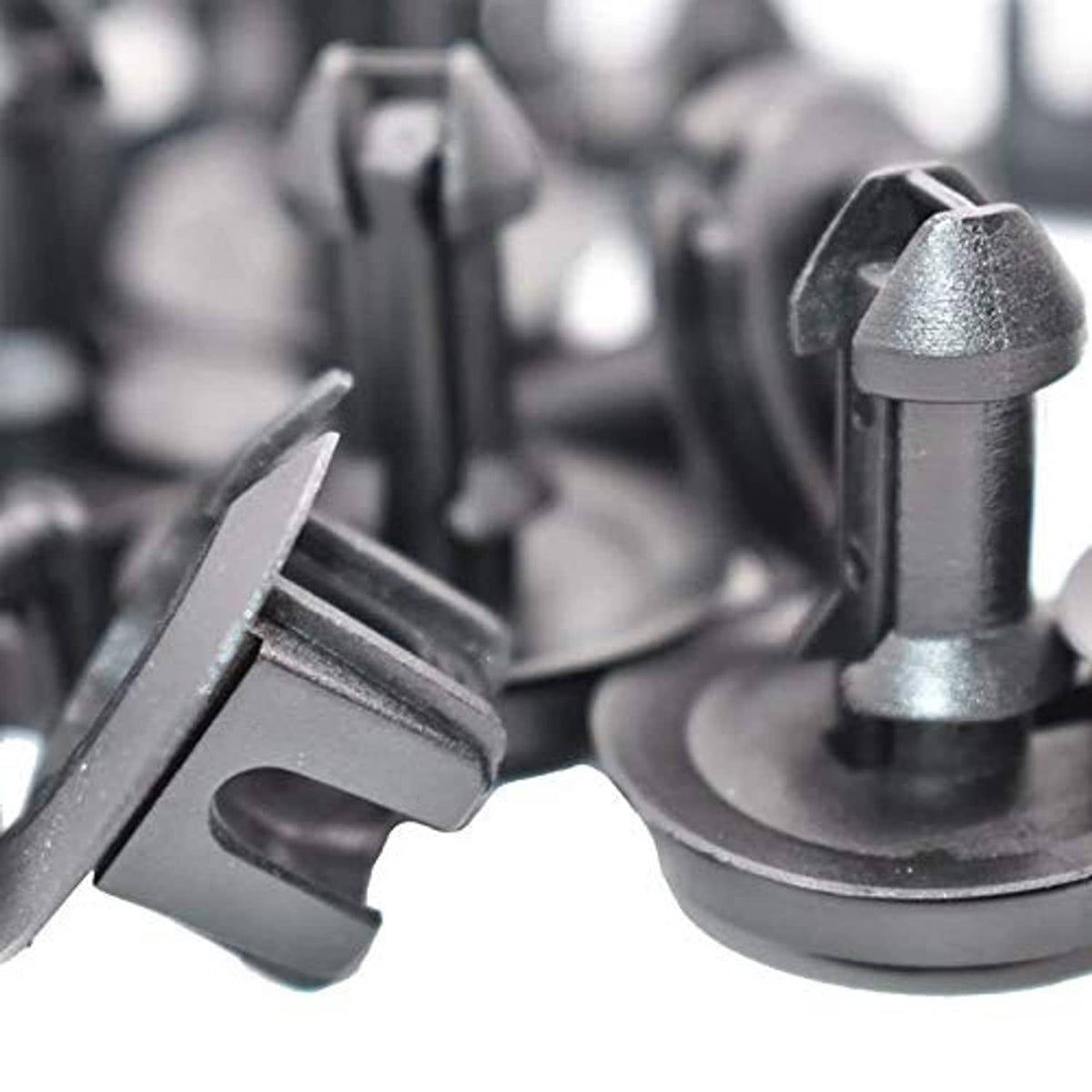 Close-up of dark gray front air deflector retainer clips and grommets
