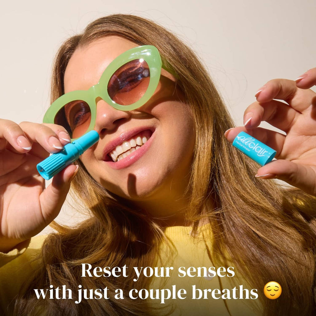 Turquoise herbal inhaler stick used near the mouth, with second stick visible