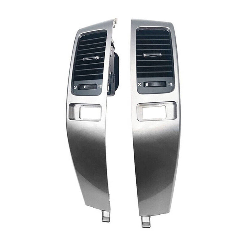 Pair of dashboard air vent panels with silver trim and black grille