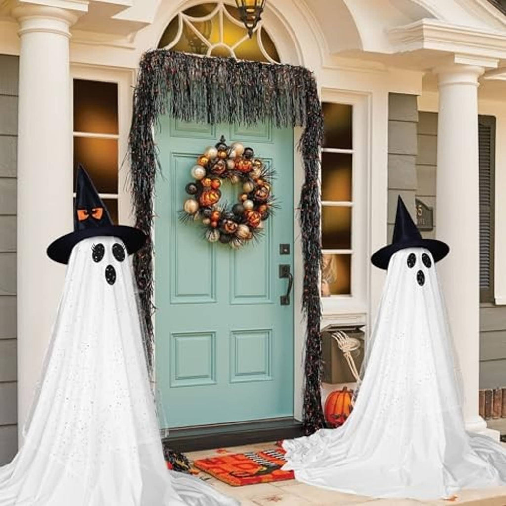 Two standing ghost decorations with black hats and oval dotted faces, white flowing fabric for outdoors.