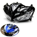 Front headlight assembly with clear lenses and black housing, central triangular lamp