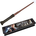 Illuminating magic wand with brown shaft, dark carved grip, and lit white tip