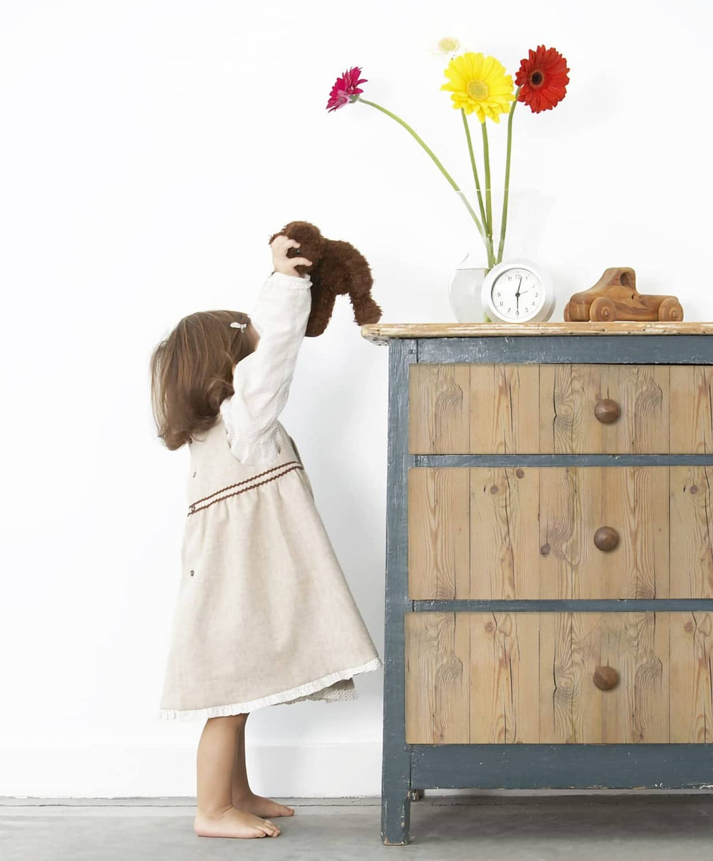 Light tan wood plank wall covering with vertical grain and scattered knot dots