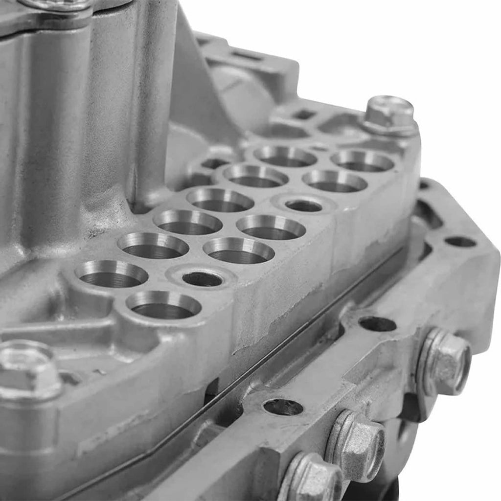 Vehicle valve body assembly close-up of machined metal passages and mounting points