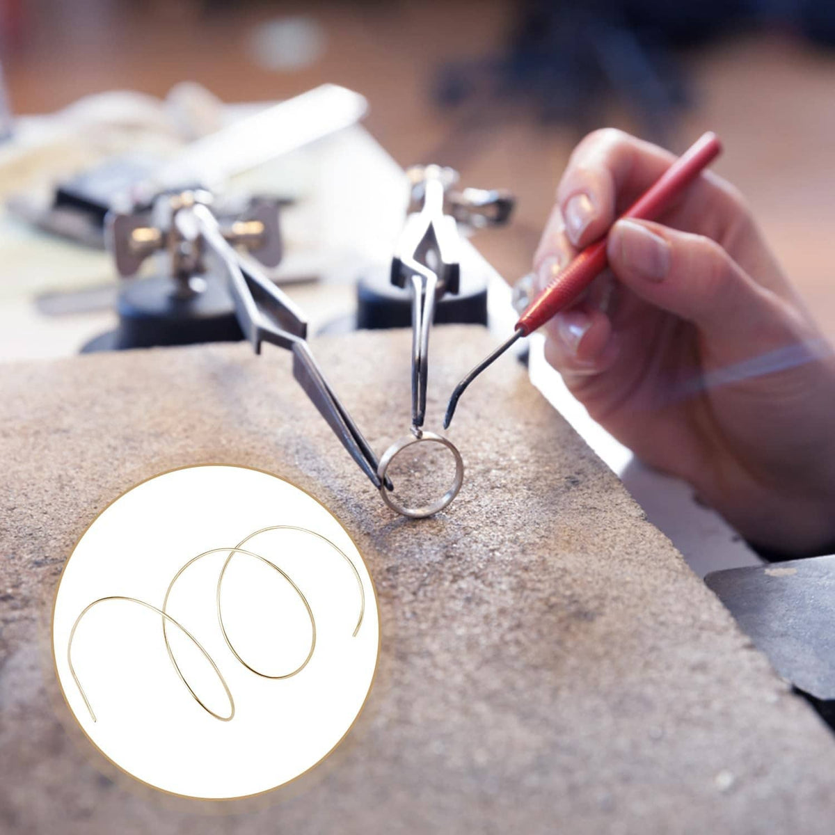 Gold-plated solder wire coil near a small jewelry piece while soldering