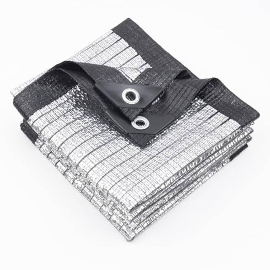 Silver reflective tarp with black hem and two grommets, folded corner closeup