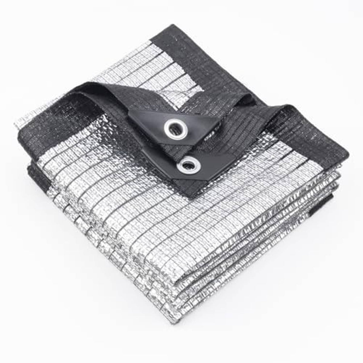 Silver reflective tarp with black hem and two grommets, folded corner closeup