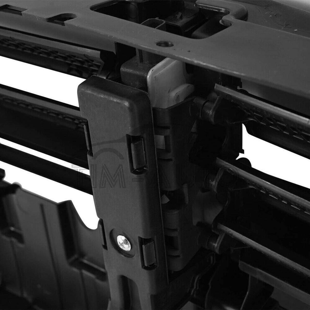 Radiator active grille shutter with motor, close-up of black actuator bracket with screw