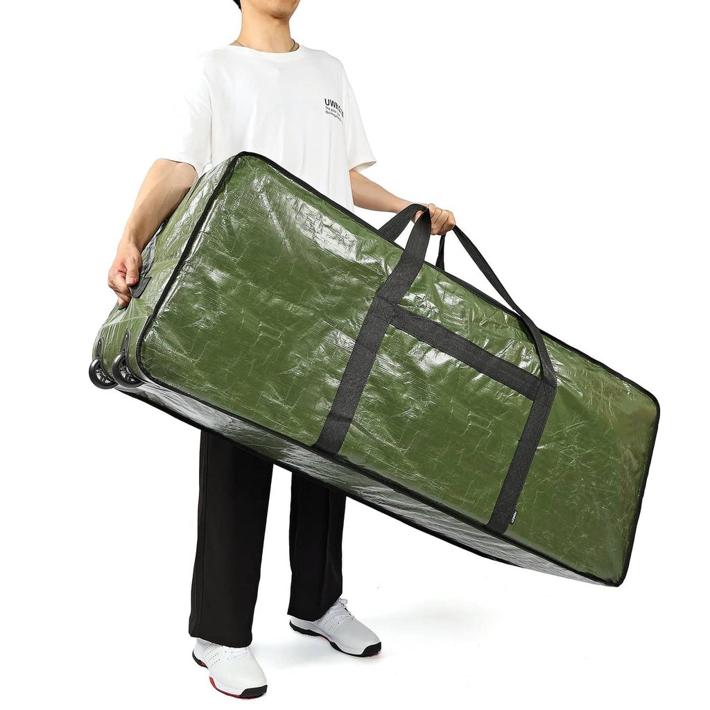 Green Christmas tree storage bag with wheels and black straps, carried by person
