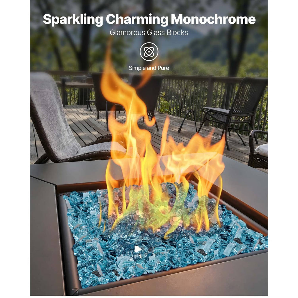 Aqua blue glass stones filling a fire pit bed with visible flames