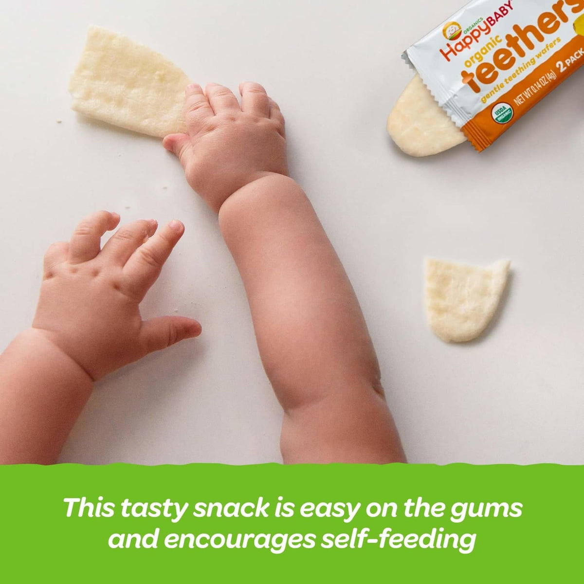 Baby hands reaching for light-colored teething wafers with package nearby