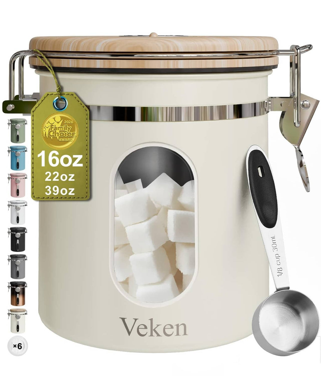 Cream stainless canister front with oval viewing window, hinged lid, and latch clamps