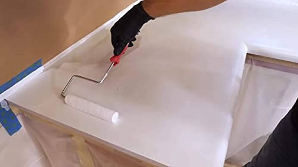 Epoxy undercoat poured and smoothed on a countertop surface with a spreader