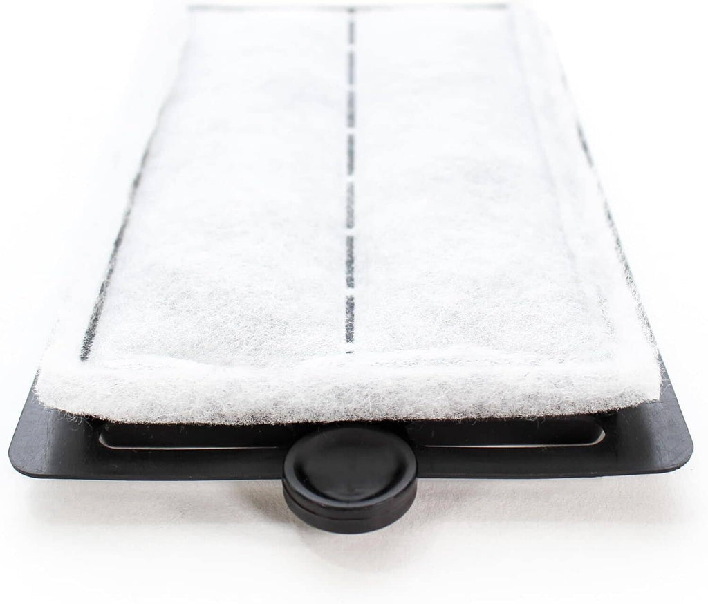 White foam filter pad in a black tray with a round release button