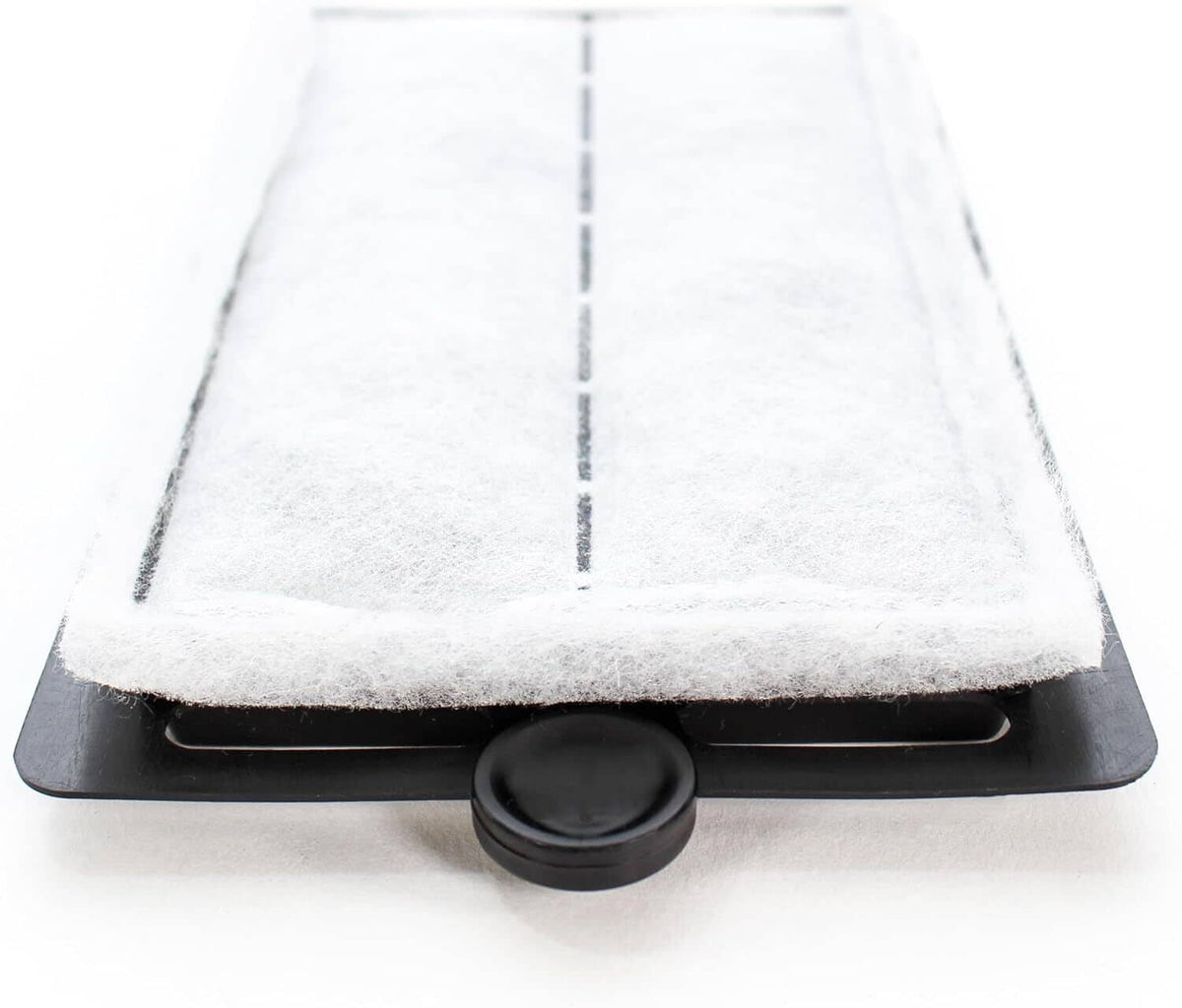 White foam filter pad in a black tray with a round release button