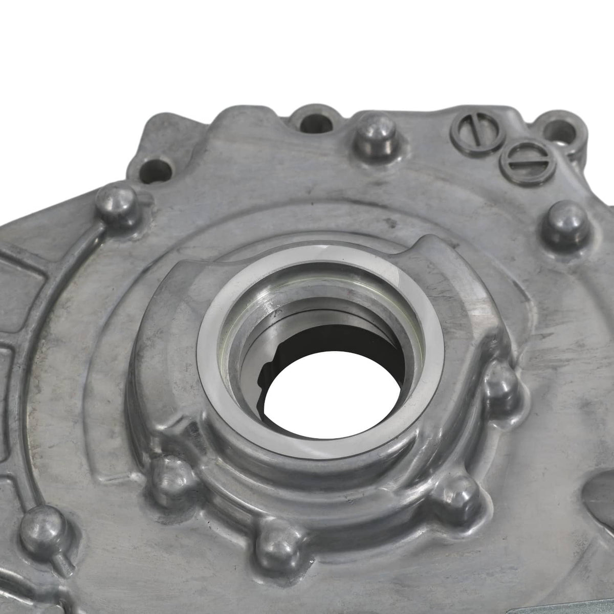 Oil pump housing with large circular opening and surrounding retaining bolts