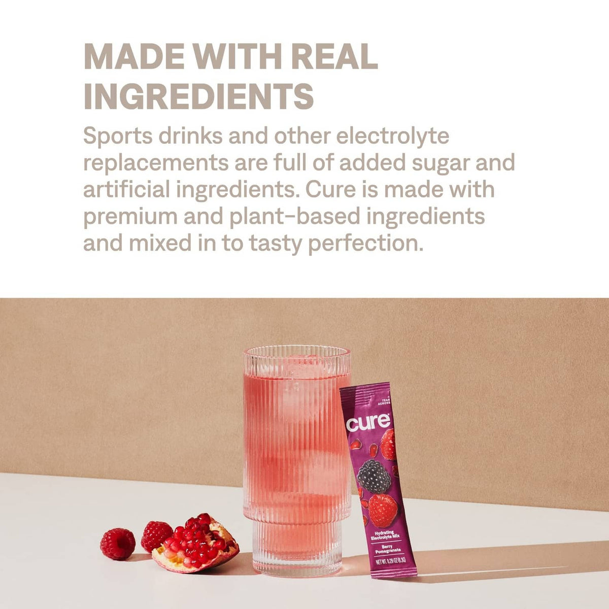 Glass of berry electrolyte drink with Cure pouch and real ingredients information panel