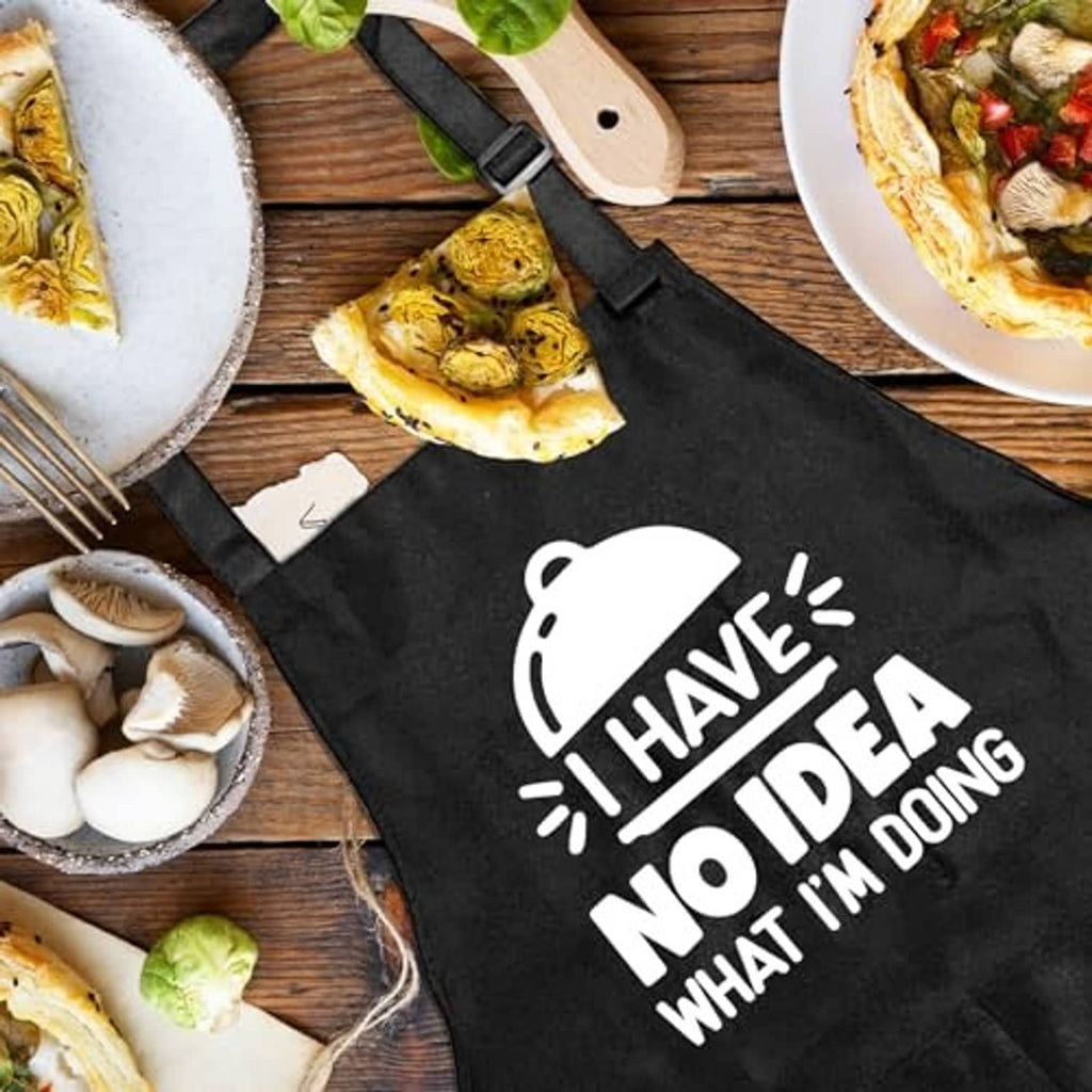 Black apron with front graphic and text "I have no idea" and utensil icon