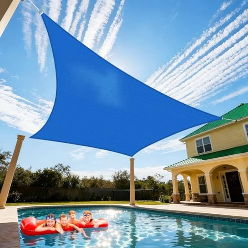 Blue rectangular sun shade sail stretched between posts over a swimming pool area.
