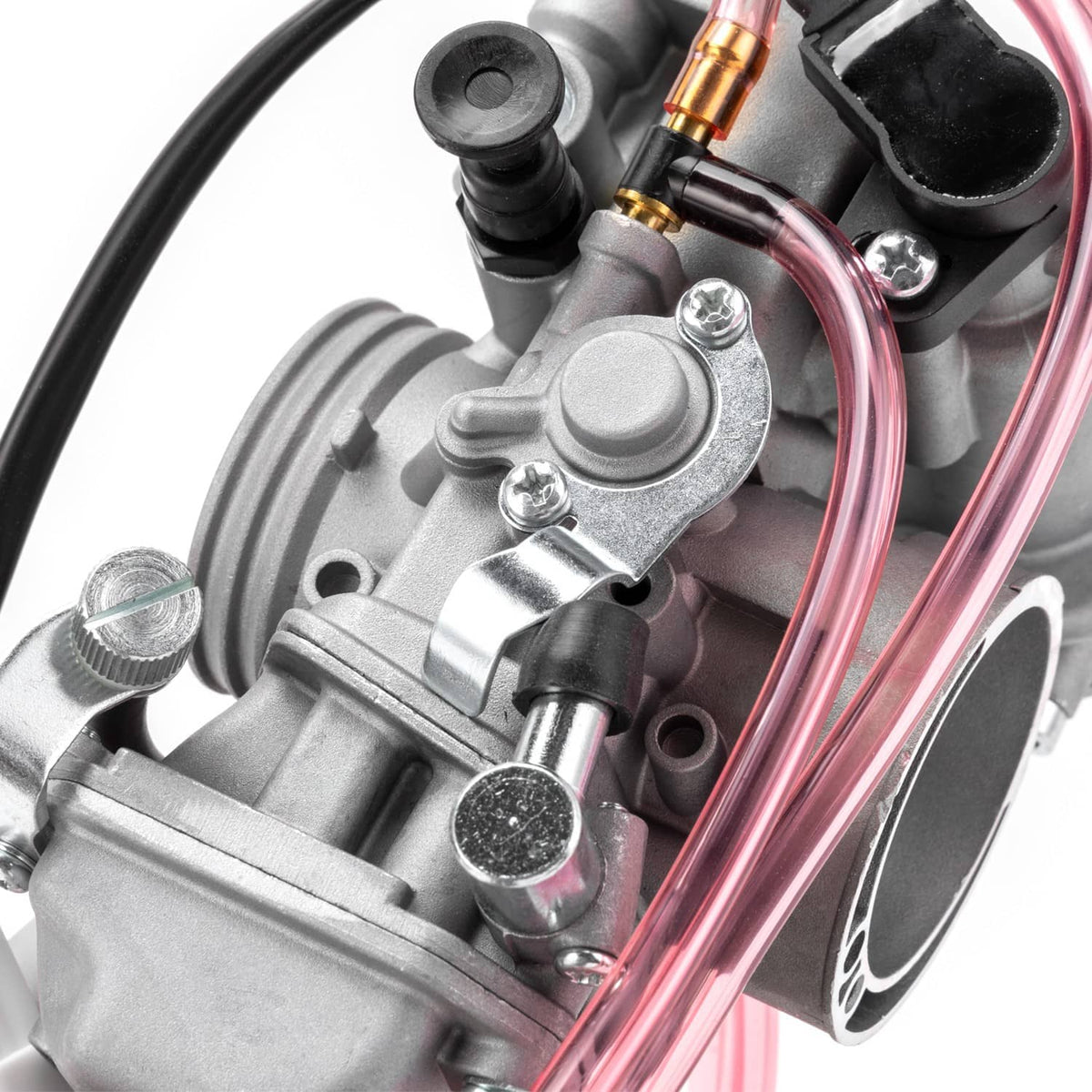 Carburetor top fittings and adjustment parts on gray body with pink fuel lines