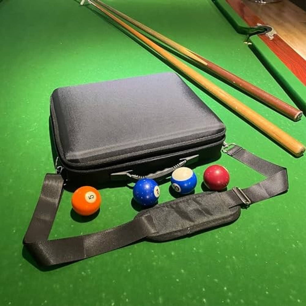 Hard pool ball carrying case open on table, molded slots and ball storage tray, dark gray.