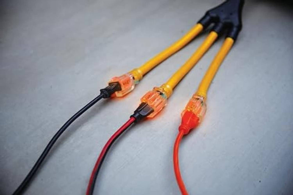 Close-up of yellow adapter cord with three plug ends and orange locking connectors