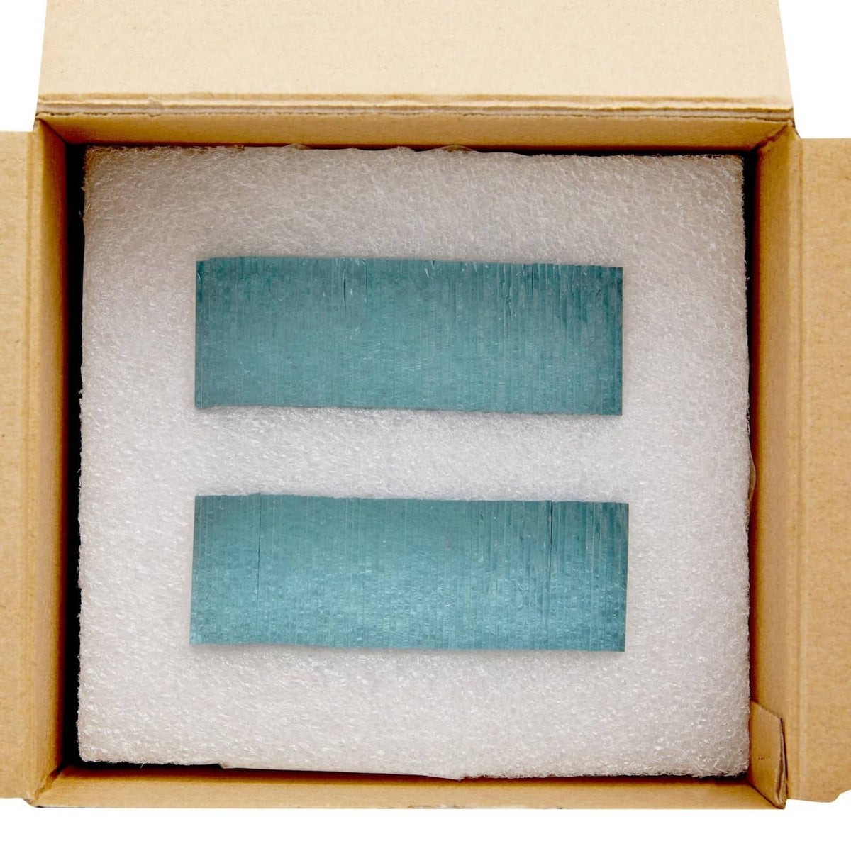 Small square glass mirror tiles packed in a box with protective foam insert
