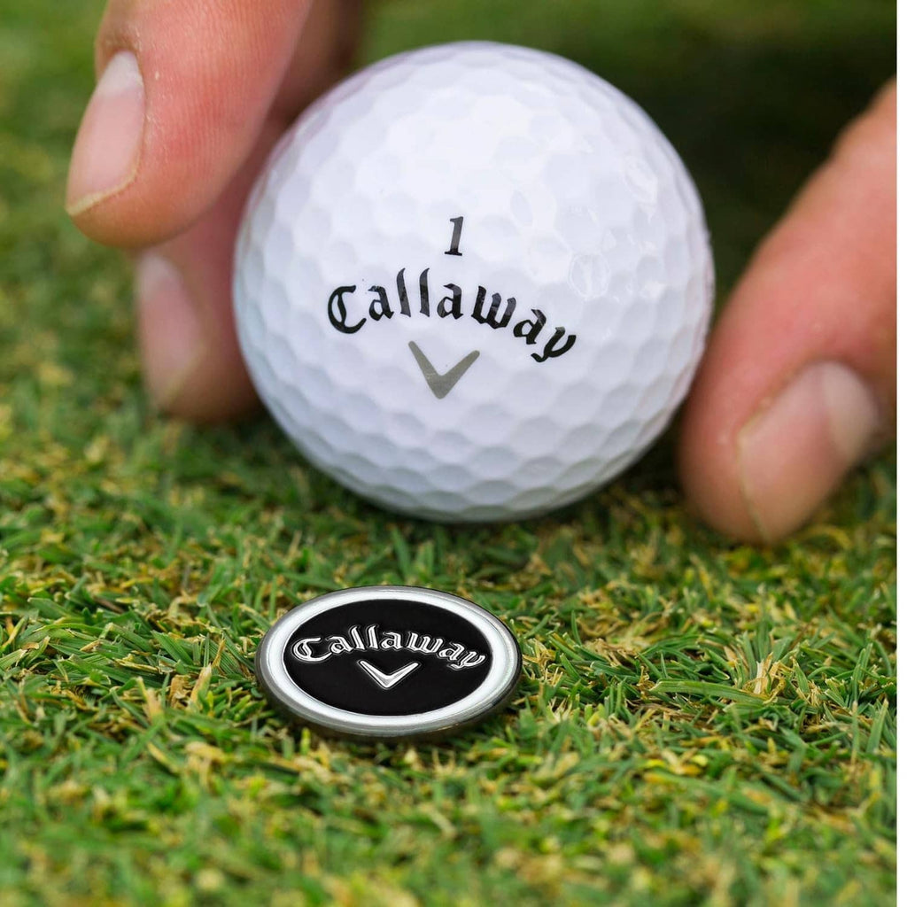 Callaway golf ball with magnetic hat marker clip on green grass
