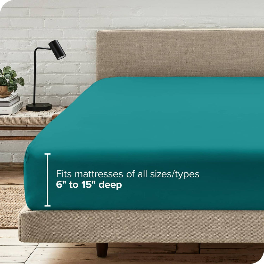 Teal green fitted sheet draped over mattress frame edge