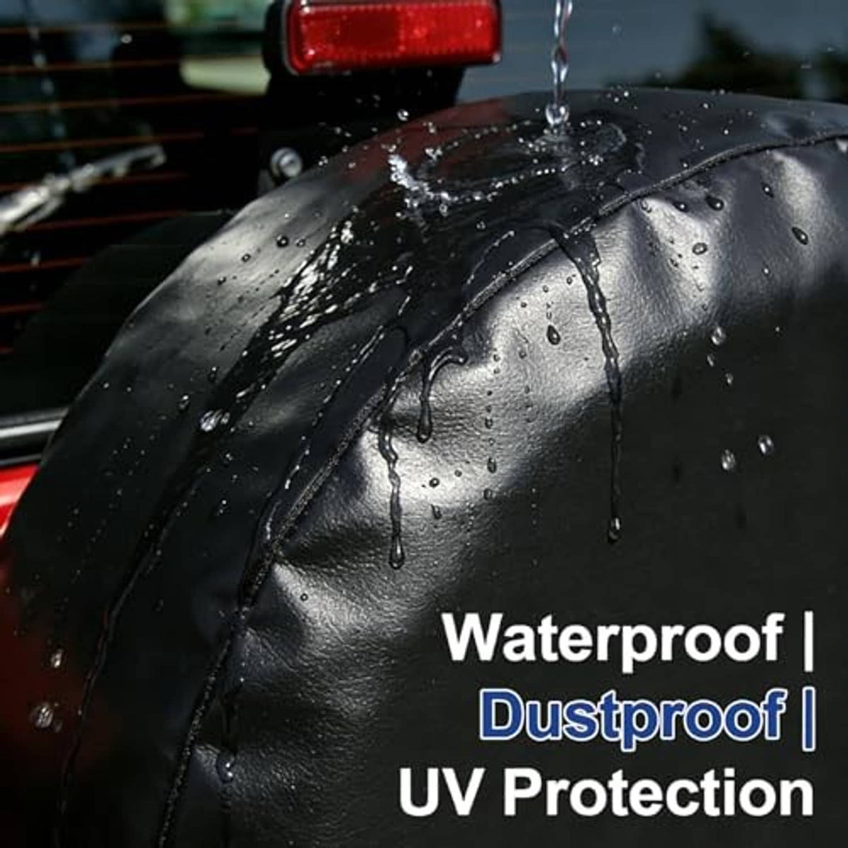 Black spare tire cover with water droplets on textured surface and seams