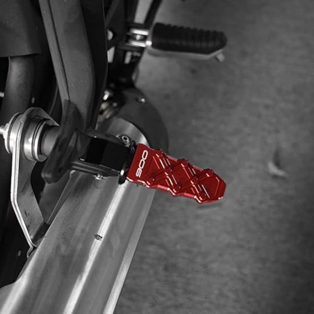 Motorcycle frame slider installed on front fork, showing red CNC accent piece
