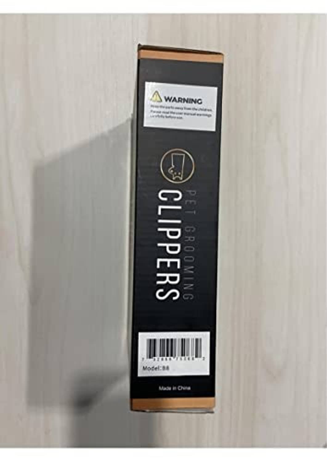 Dog grooming clipper packaging box with warning label and model information