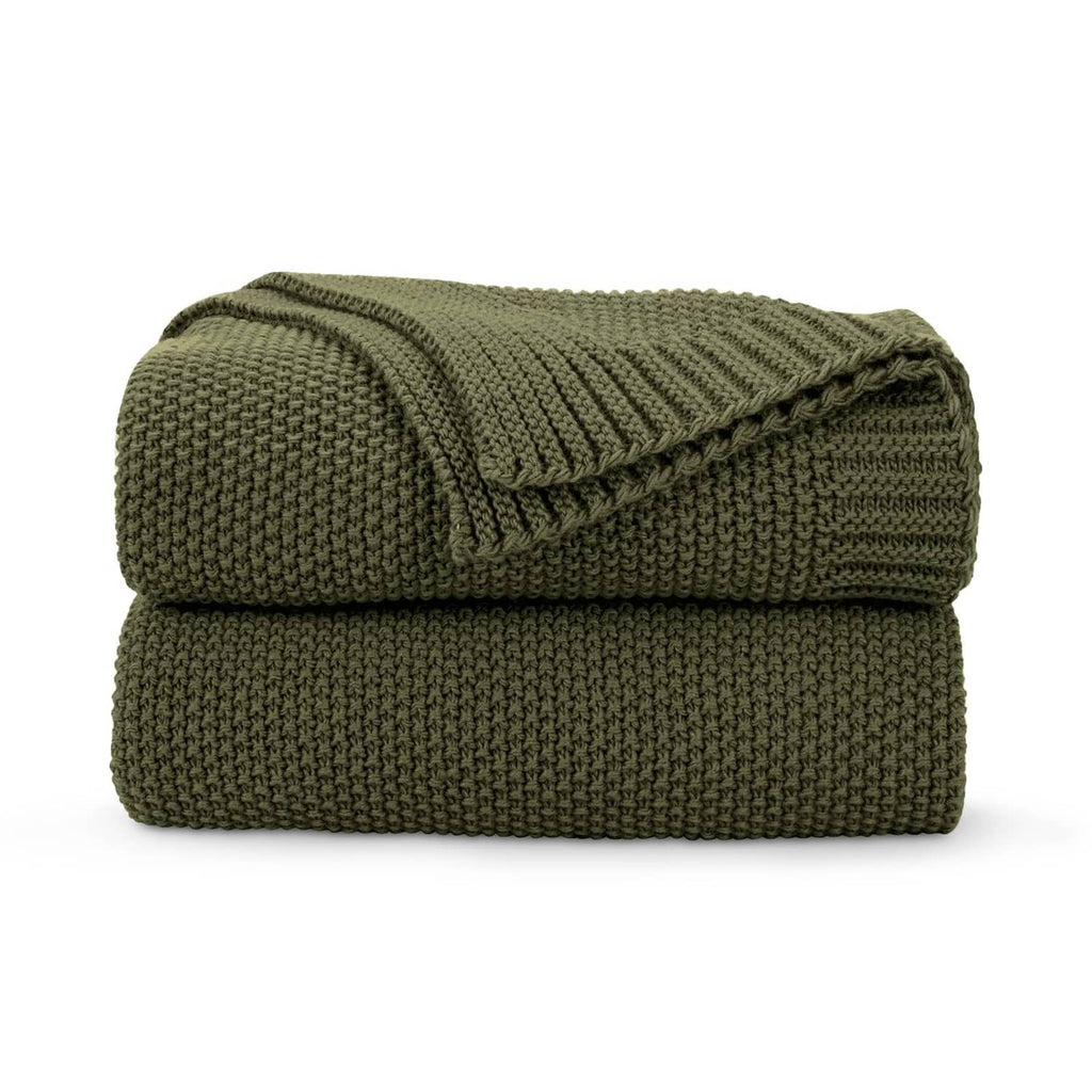 Olive green chunky knit throw blanket, folded with ribbed texture.